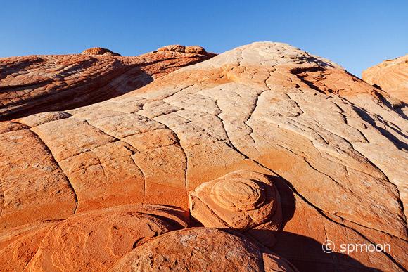 Yant Flat - red, orange, and white unusual striped rock formation located in Southern Utah at sunset.