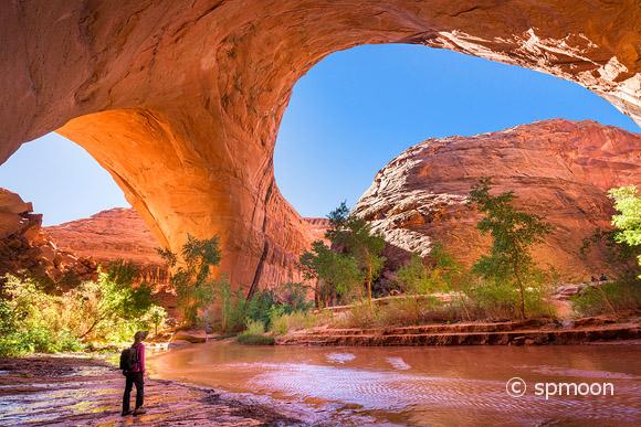 A hiker at Jacob Hamblin Arch in Coyote Gulch, Grand Staircase-Escalante National Monument, Utah, United States
